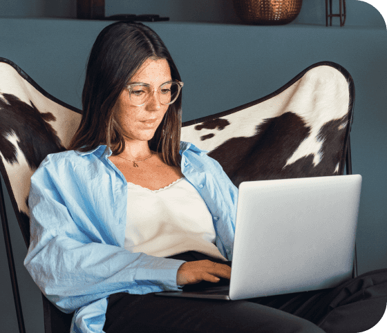Woman slouching in chair and using laptop