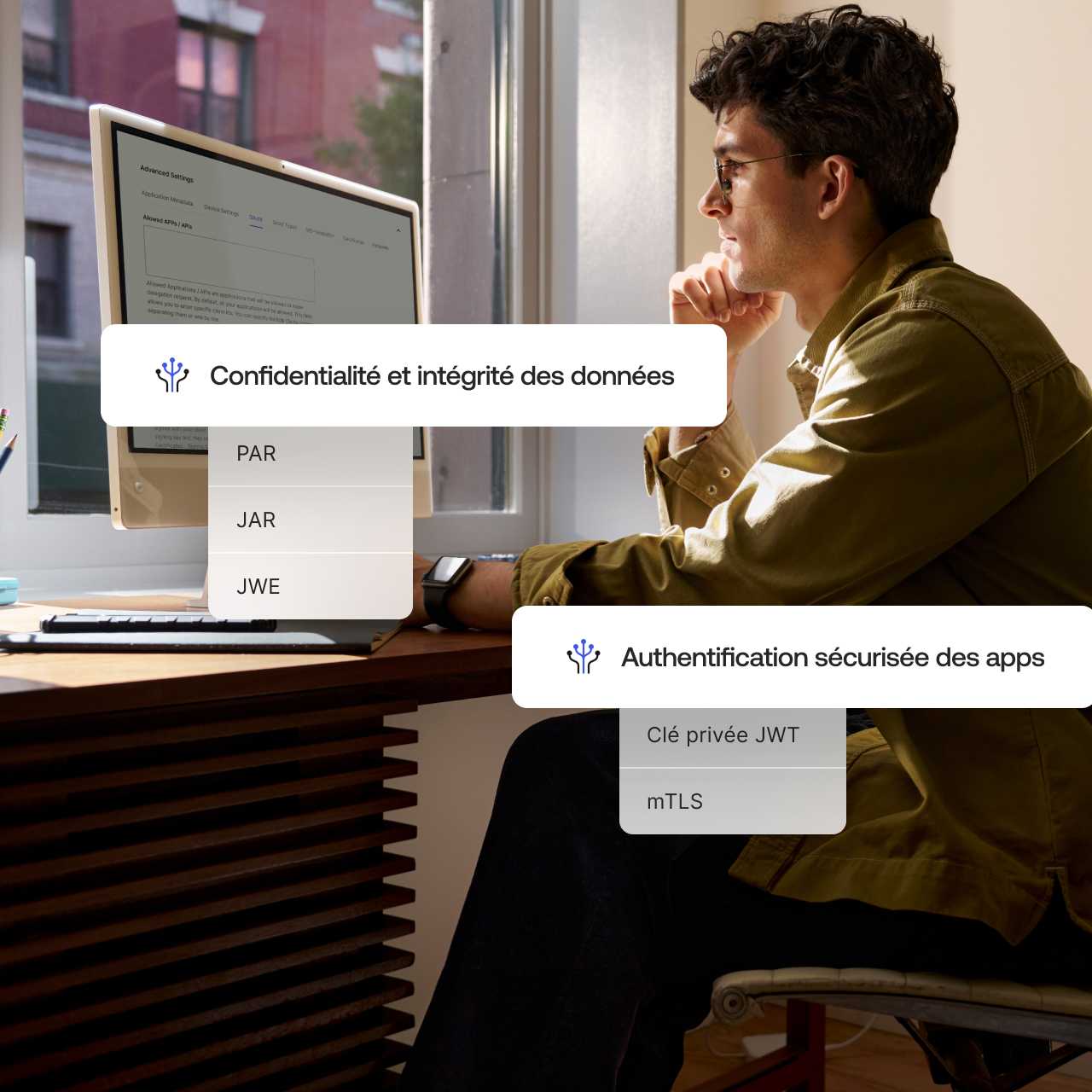 The words Data Privacy and Integrity and Secure App Authentication overlaying an image of a man working on desktop computer.