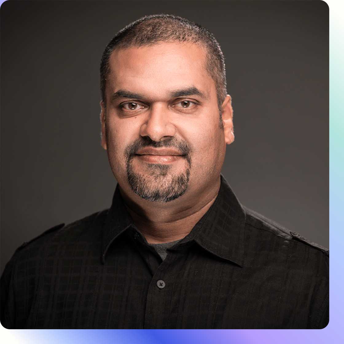 Headshot of man wearing black button up shirt