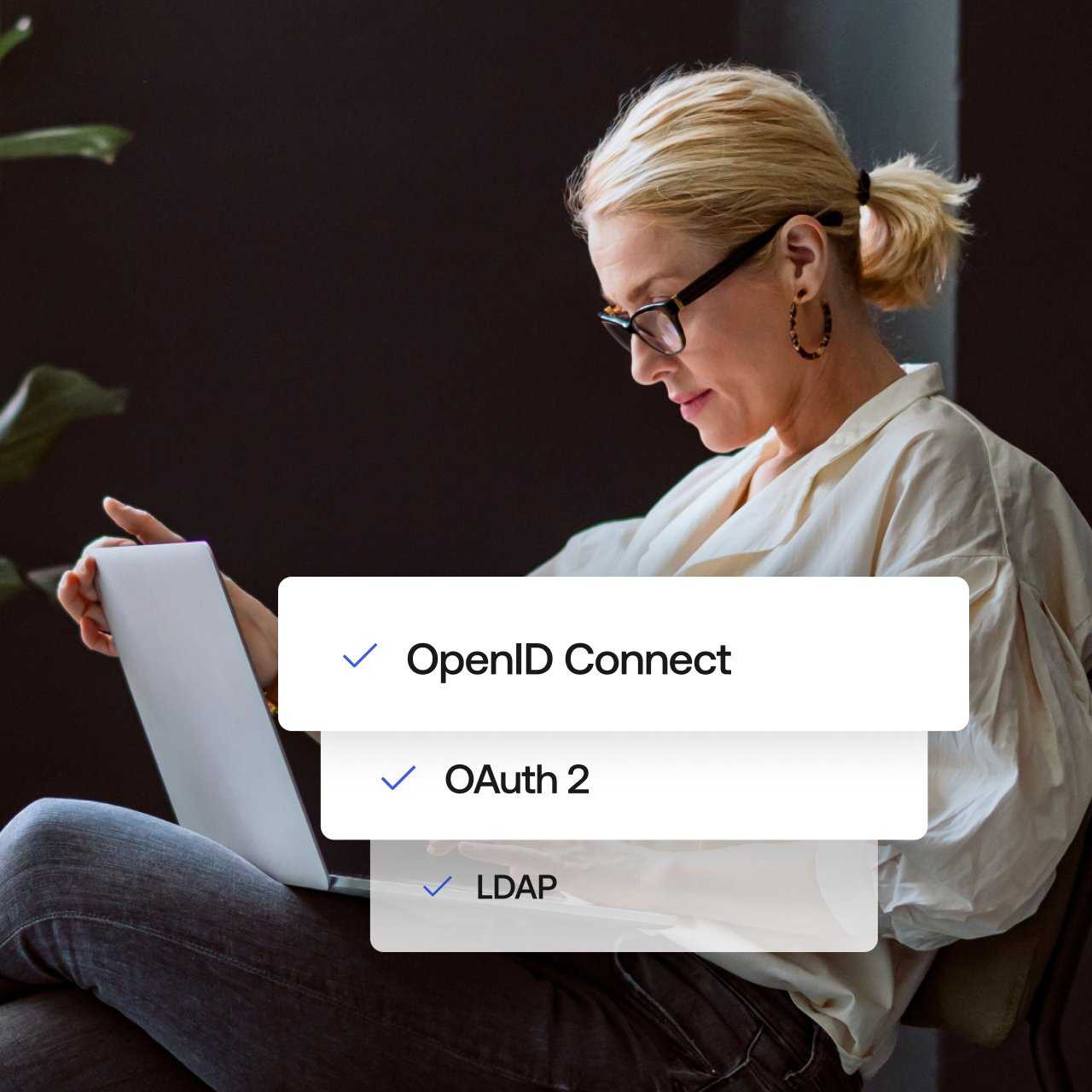 A woman sits on her laptop with three pop outs showing OpenID Connect, OAuth 2, and LDAP
