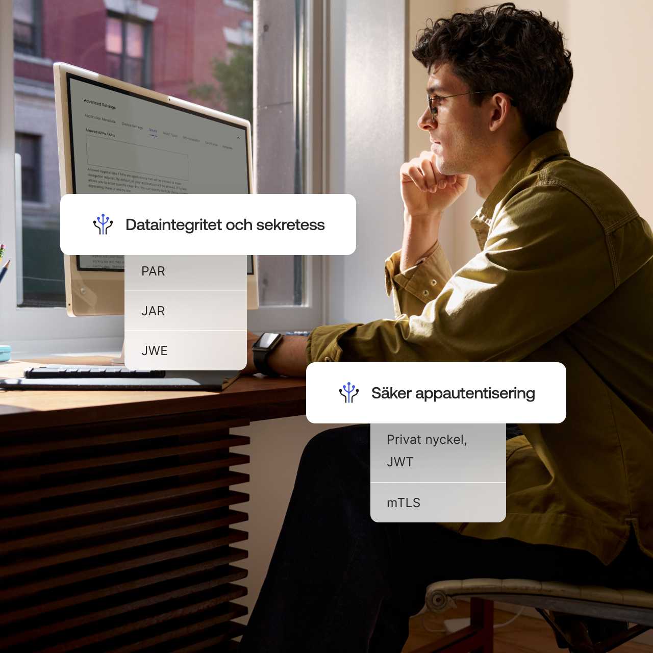 The words Data Privacy and Integrity and Secure App Authentication overlaying an image of a man working on desktop computer.
