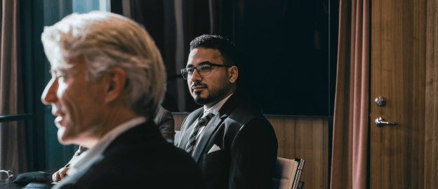 Juniper Square card showing business professionals in formal meeting room