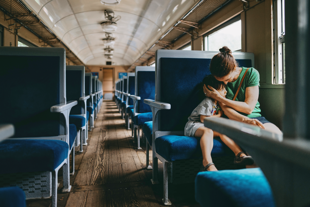 A mother comforting her child in the train.