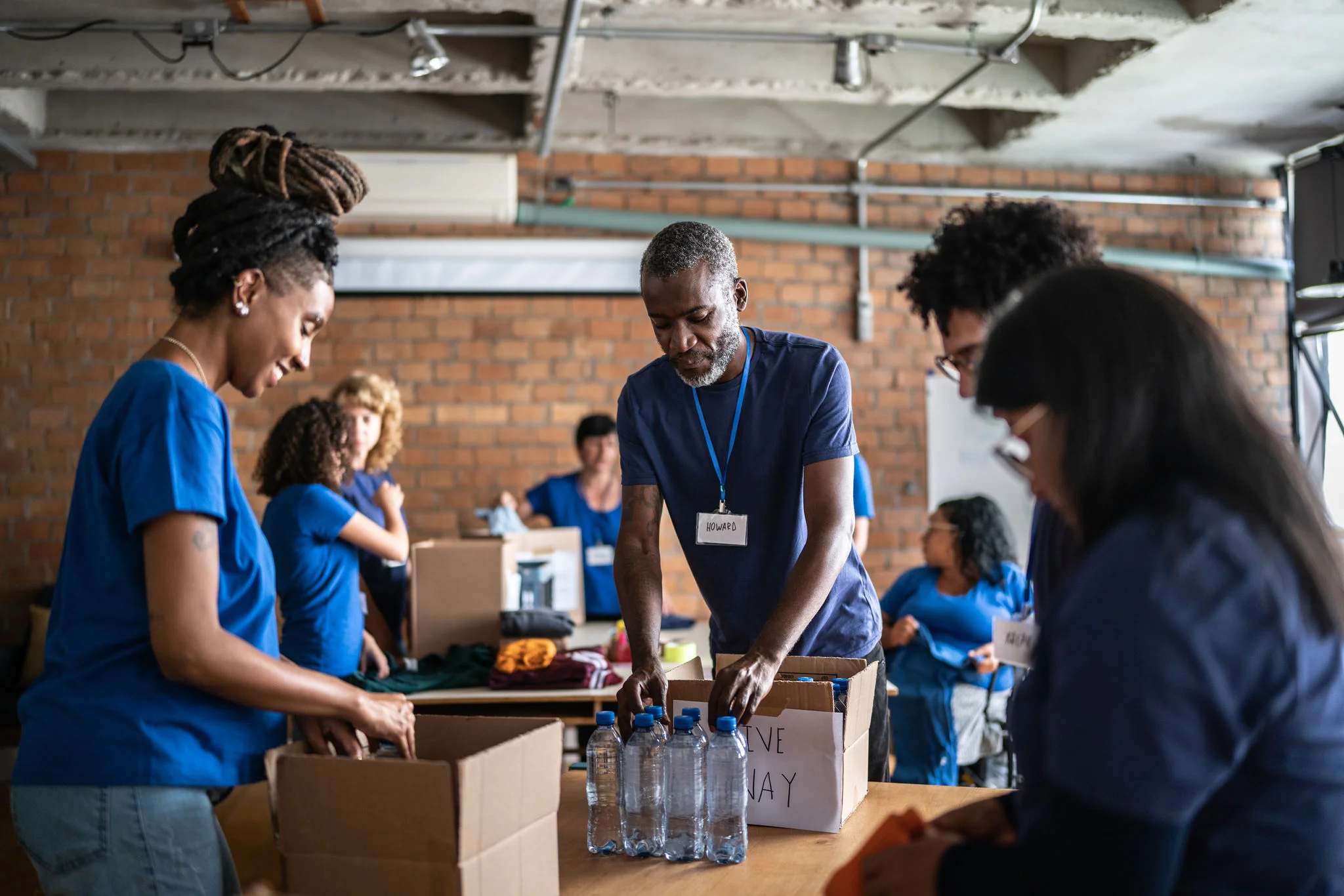 Volunteers arranging donations in a community charity donation center.