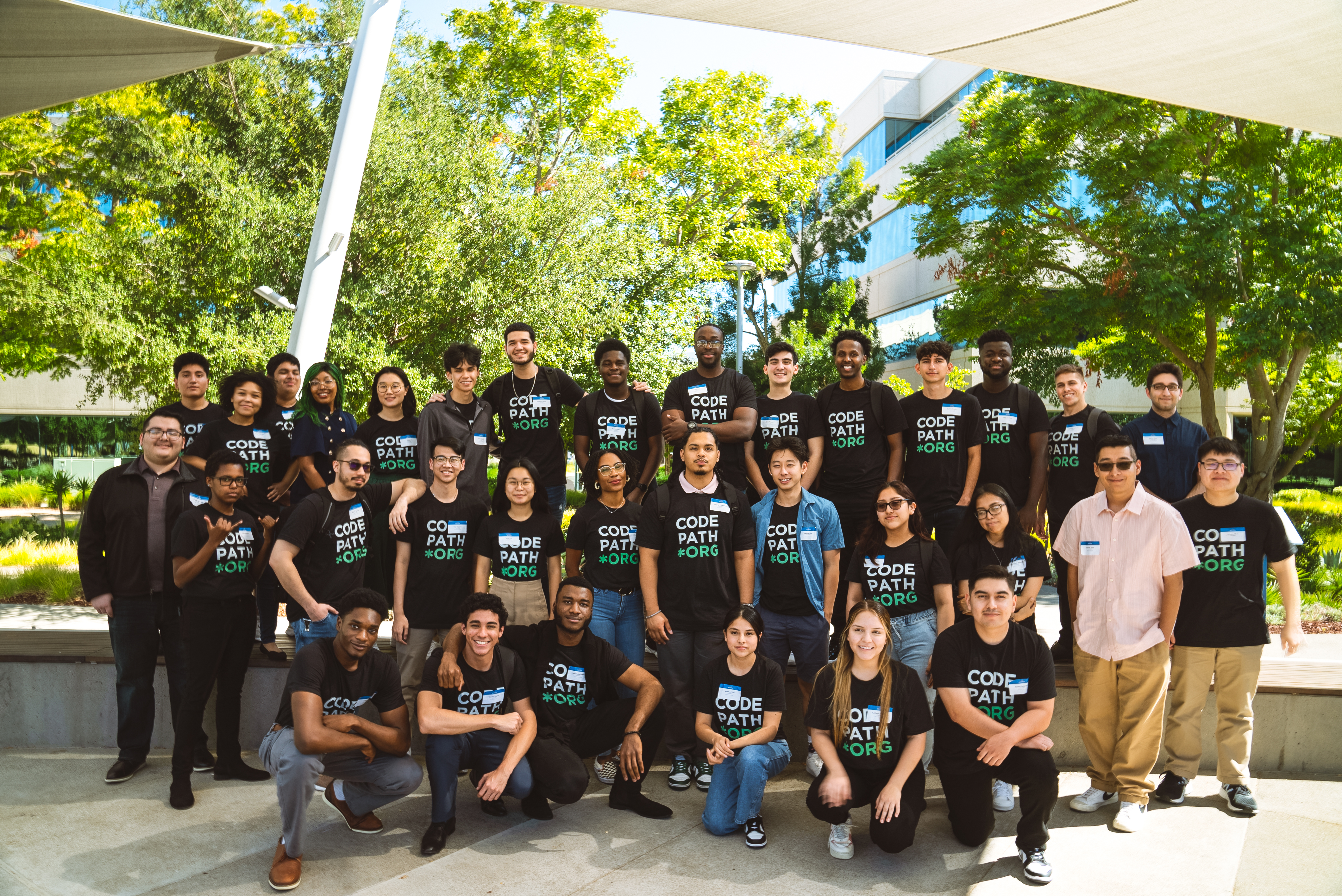 Diverse group of people from CodePath posing outdoors.