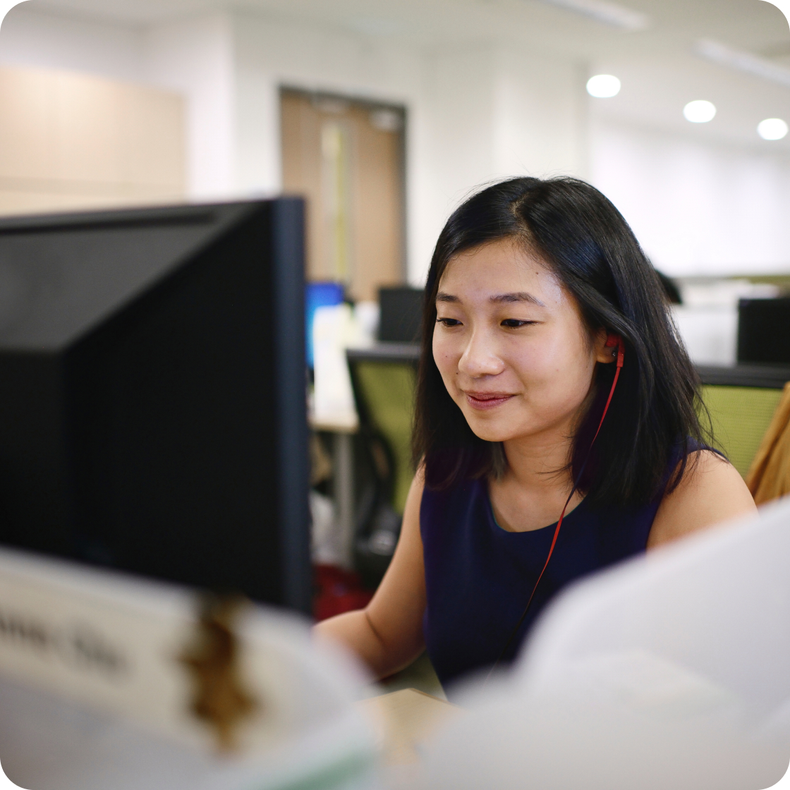 A young woman sitting in the office and working