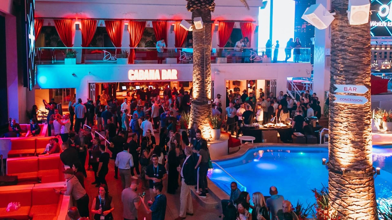 Oktane attendees networking at a lively poolside party at the Cabana Bar.