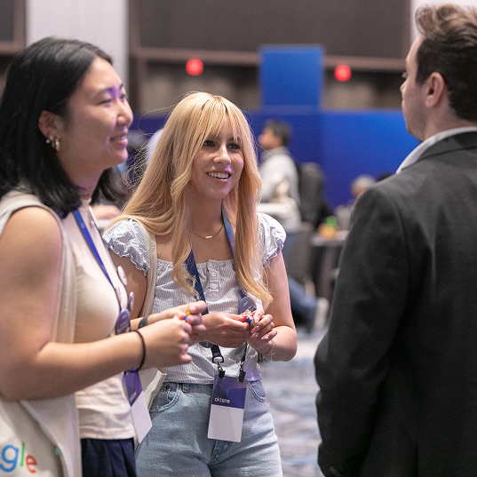 Three Oktane attendees chatting.