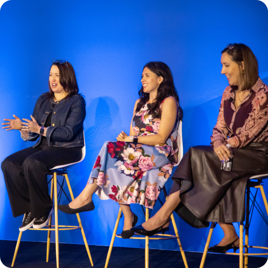 Three women sitting on panel at Oktane. 