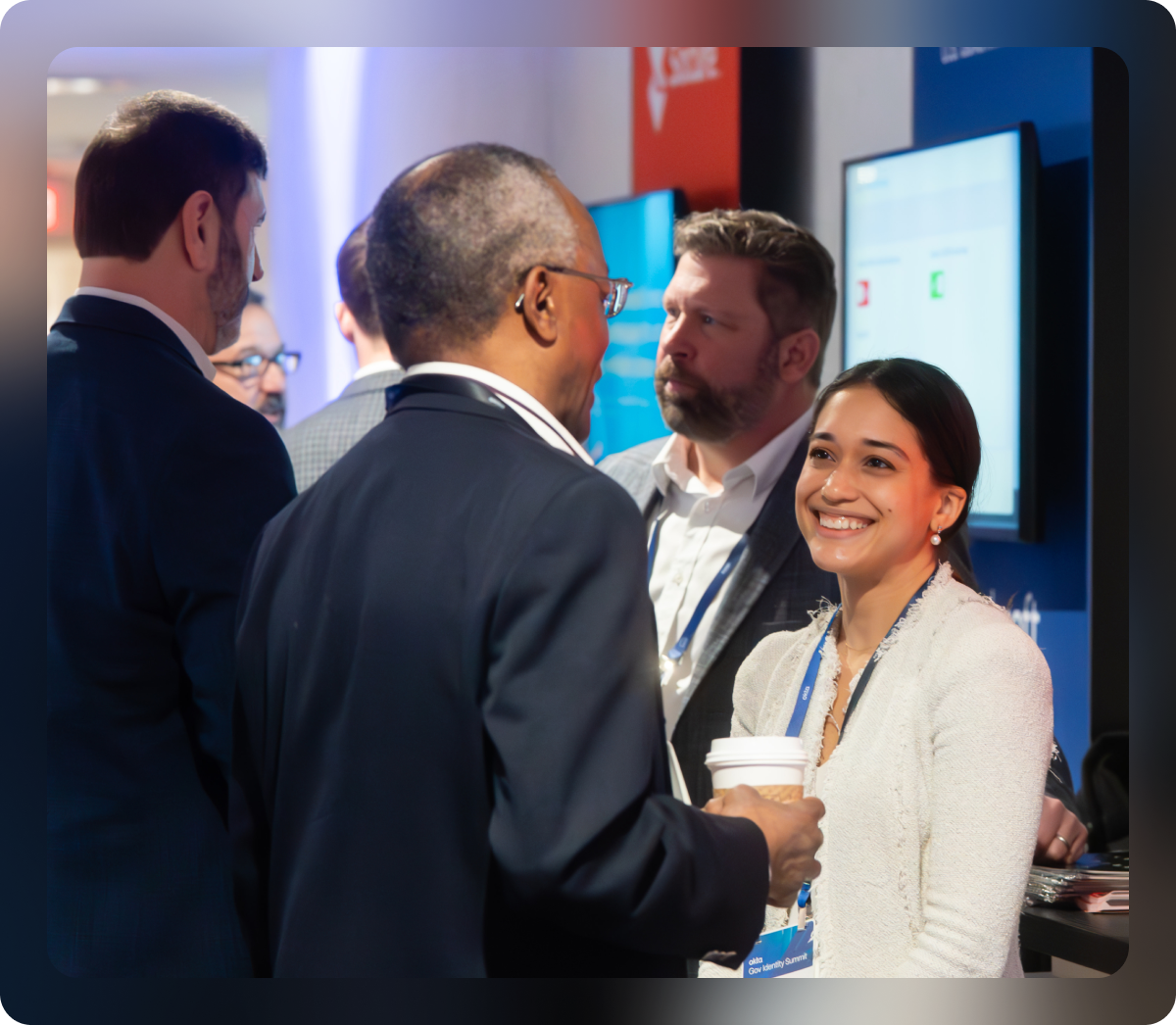 A close-up shot of a small group of four business professionals networking at an event.