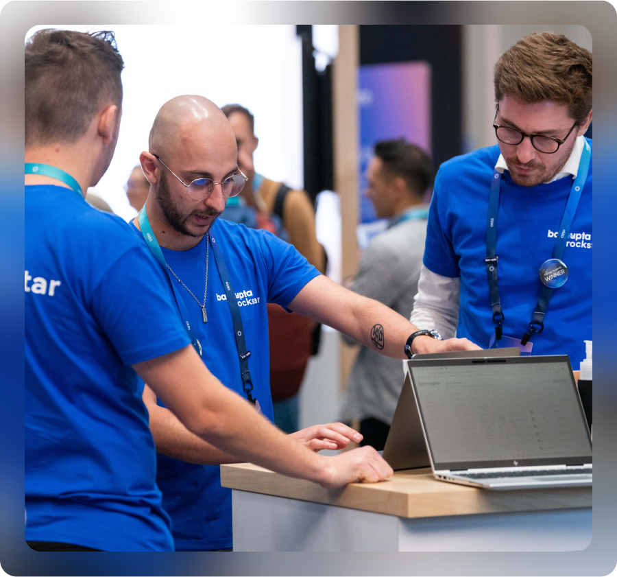 Three Oktane volunteers working at booth.
