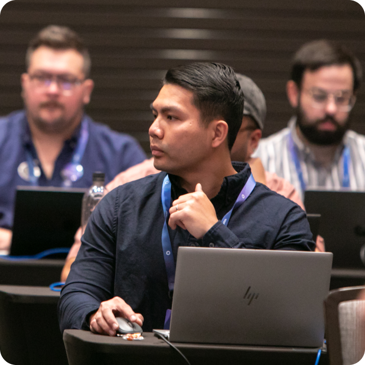 Oktane attendees sitting with laptops