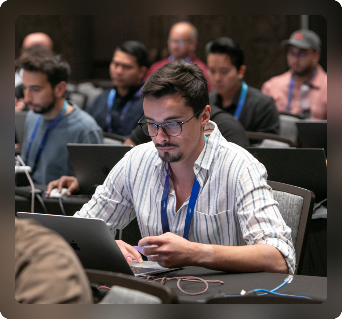 Oktane attendees sitting with laptops