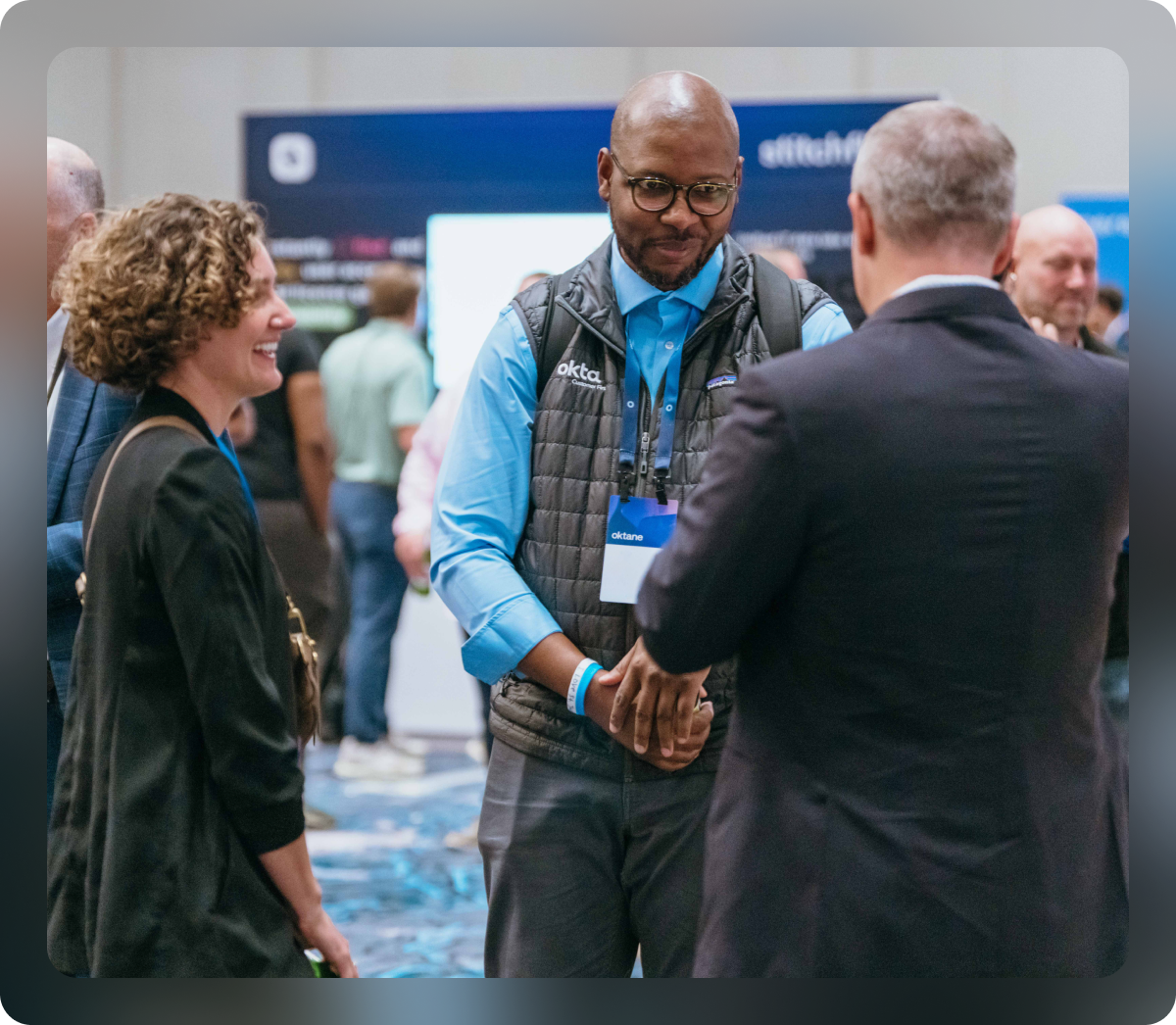 Oktane attendees chatting in conference hall