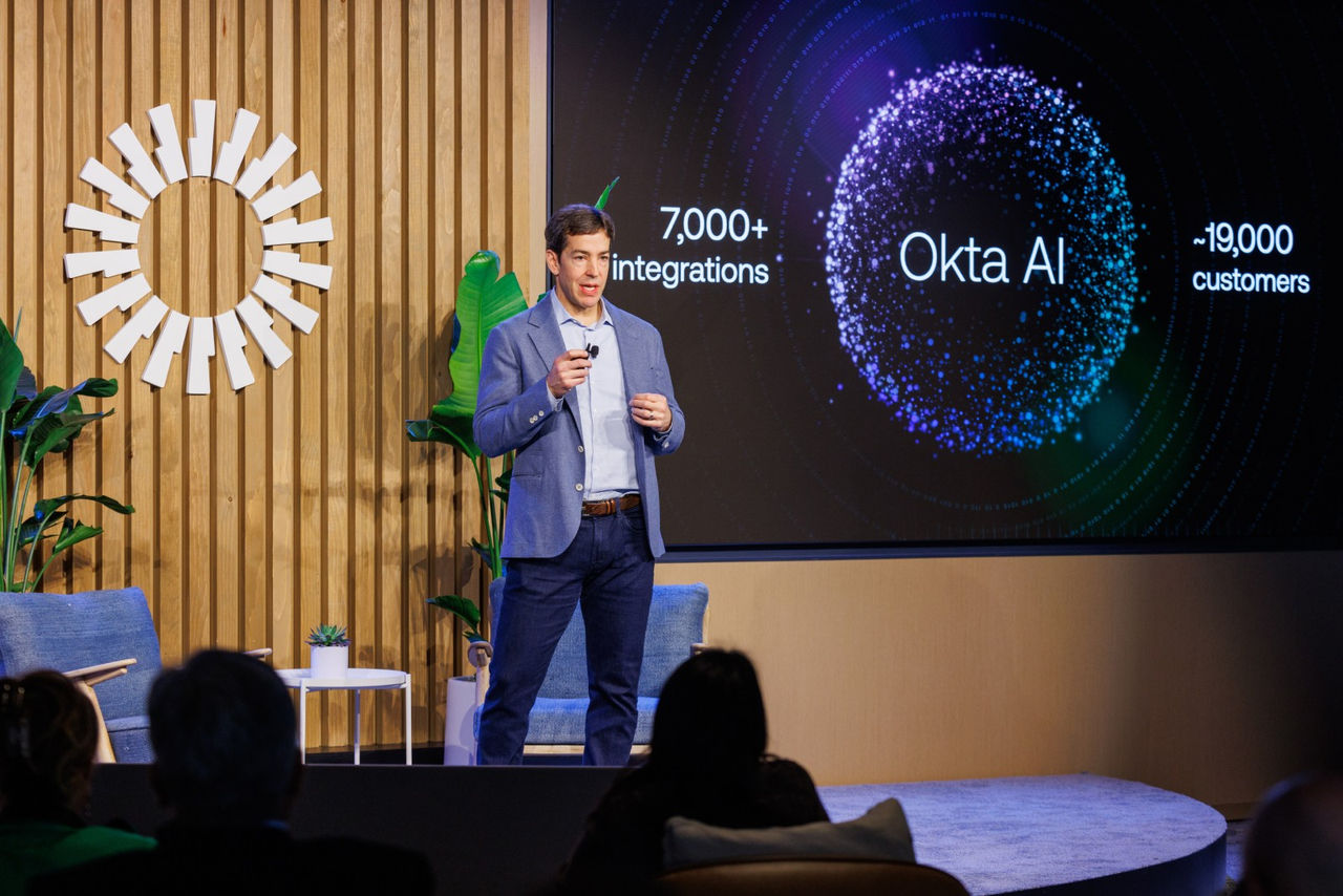 Todd McKinnon, CEO & Co-Founder at Okta presenting slide on a large stage screen displaying key statistics and data points.
