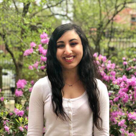 Noorisingh Saini in front of a floral background